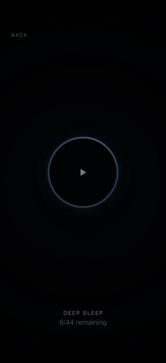 A journey paused: a ring of blue light with a play triangle at its centre, Back in the corner, and the time remaining below.